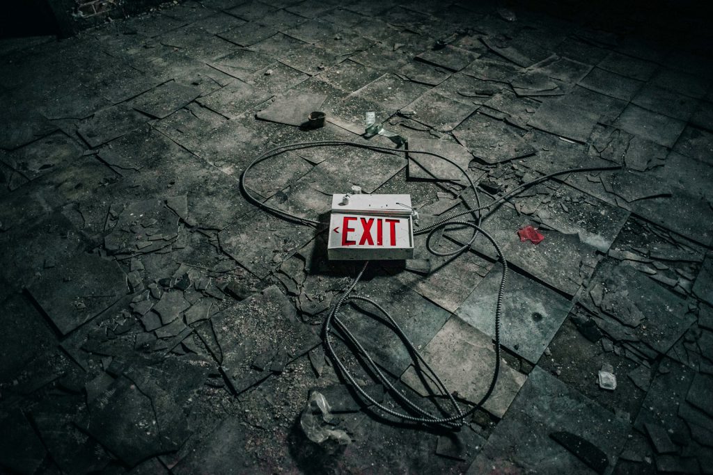 grey exit sign board on grey pavement escape rooms voor kinderen